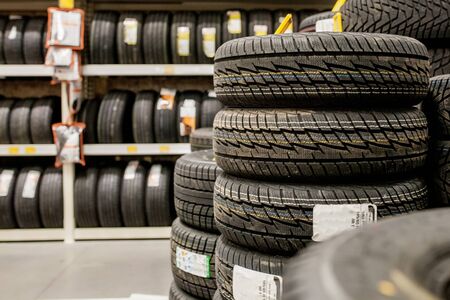 Car tires and wheels at warehouse in tire storeの写真素材