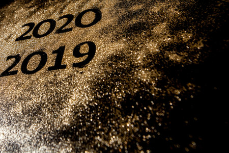 Beautiful sparkling Golden Numbers of 2019 to 2020 on black background for design, happy new year...