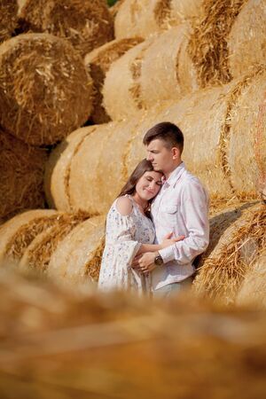 Happy young couple on straw, romantic people concept, beautiful landscape, summer season.の写真素材
