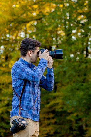 Professional photographer in action with two cameras on a shoulder straps.