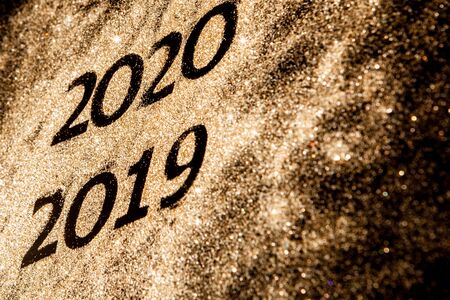 Beautiful sparkling Golden Numbers of 2019 to 2020 on black background for design, happy new year concept.の写真素材