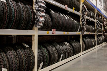 Ivano-Frankivsk, Ukraine, August 26 2019: Rack with variety of car tires in automobile store.のeditorial素材