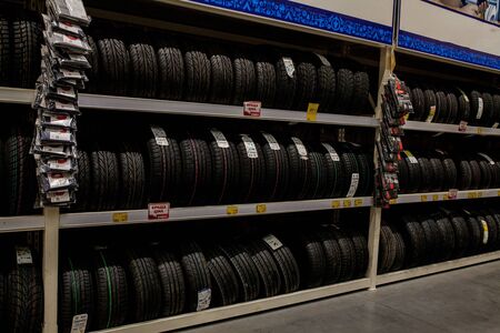 Ivano-Frankivsk, Ukraine, August 26 2019: Rack with variety of car tires in automobile store.のeditorial素材