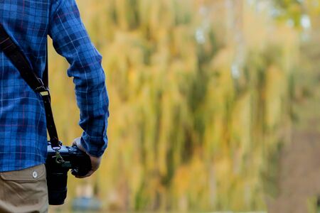 Professional photographer in action with two cameras on a shoulder straps.の写真素材