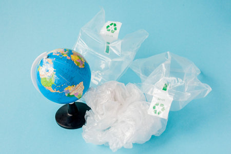 Ban plastic pollution. Globe and plastic bag out of the globe. Creative concept.