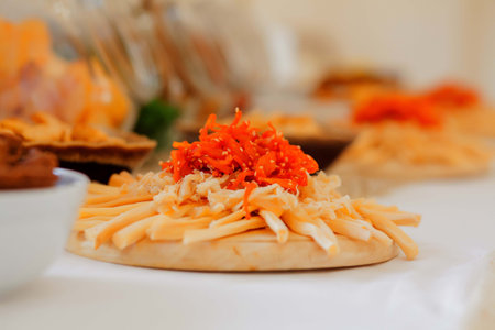 A lots of salty snacks on a table, many cheese and crackers on the table with snacks.