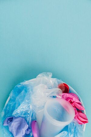 Top view of various kinds of disposable plastic waste on blue background, copy space.の写真素材