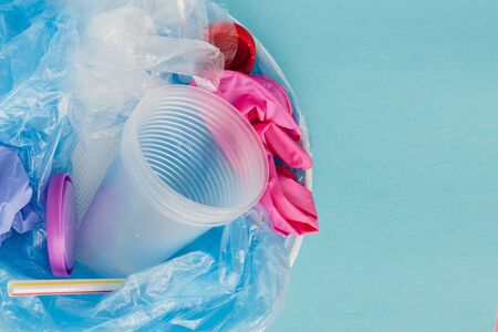Top view of various kinds of disposable plastic waste on blue background, copy space.の写真素材