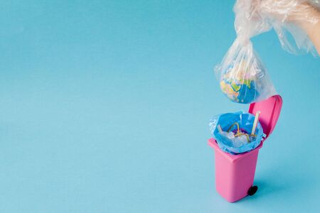 Earth globe lies in the trash. The globe lies in a heap of plastic. Plastic pollution of nature.の写真素材