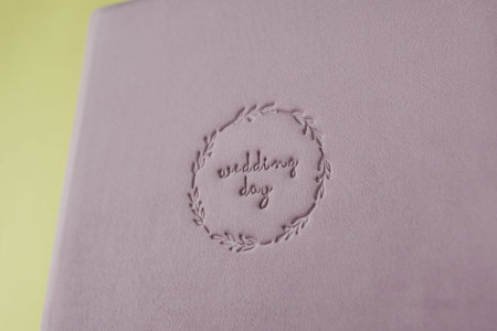 Inscription WEDDING DAY supplanted on velour wedding book.