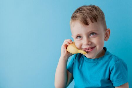 Little Boy tries to speak by means of a banana instead of phoneの写真素材