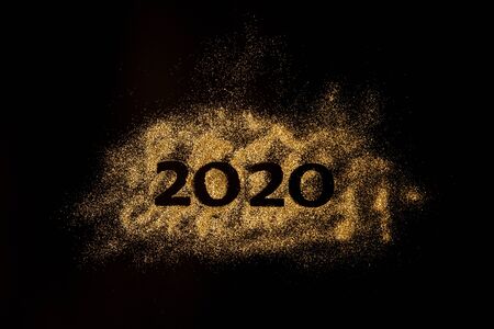 Happy New Year 2020. Creative Collage of numbers two and zero made up the year 2020. Beautiful sparkling Golden number 2020 on black background for designの写真素材