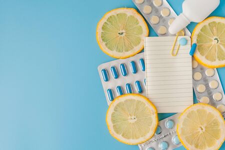 Medications, pills, thermometer, traditional medicine for treating colds, flu, heat on a blue background. Maintenance of immunity. Seasonal diseases. Top view. Medicine flat lay.の写真素材