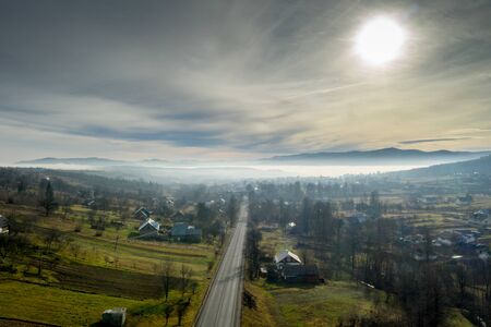 Image of beautiful village in the mountains, view of fog over little town, many houses in Lebanese mountain, gorgeous landscape, picturesque rural place, traveling and vacation concept.の写真素材