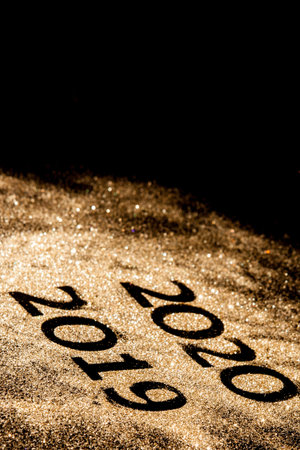 Beautiful sparkling Golden Numbers of 2019 to 2020 on black background for design, happy new year...