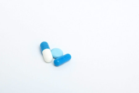 Macro view of capsule pill and tablet isolated over white background.