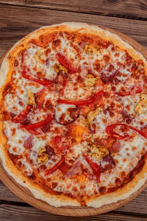 Pizza with Mozzarella cheese, salami, Tomatoes, pepper Spices Italian pizzaの写真素材