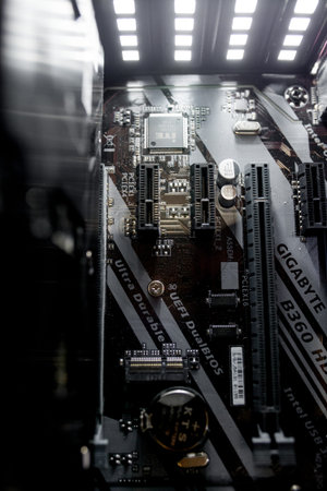 Kyiv, Ukraine - August 17, 2019: Inside of the personal computer power supply motherboard, cables,...