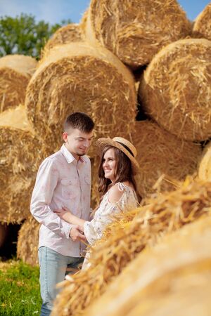 Happy young couple on straw, romantic people concept, beautiful landscape, summer season.の写真素材