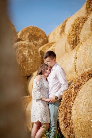 Happy young couple on straw, romantic people concept, beautiful landscape, summer season.の写真素材