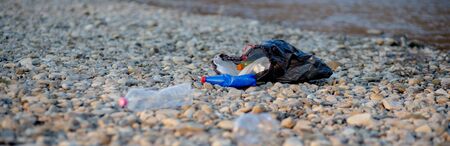 Garbage near the river. Environmental pollution shore.の写真素材