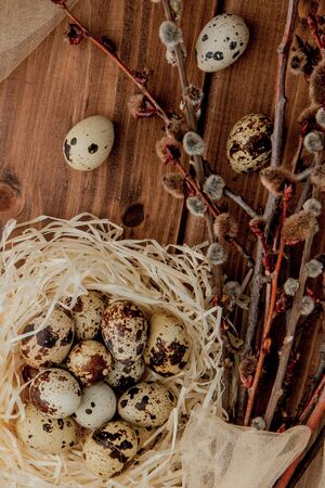 Flat lay composition of quail eggs and card with text Happy Easter on wooden table. Top viewの写真素材