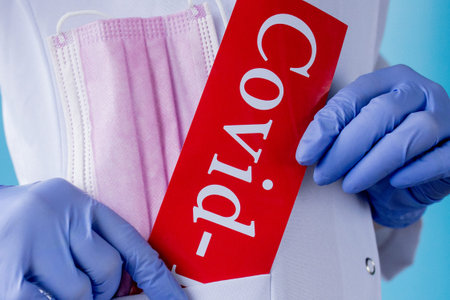 medical mask and inscription COVID-19 in Doctor's Pocket.