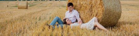 Happy young couple on straw, romantic people concept, beautiful landscape, summer season.の写真素材