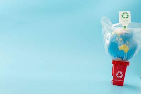 The red recycling bin on blue background.の写真素材