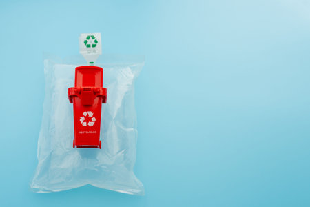 The red recycling bin on blue background.