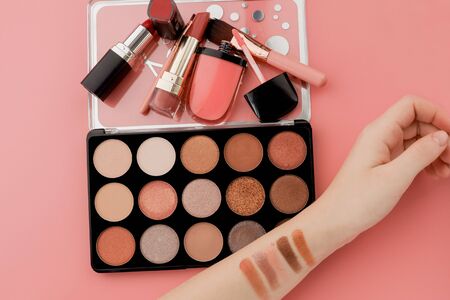 Various makeup productson pink background with copyspace.の写真素材