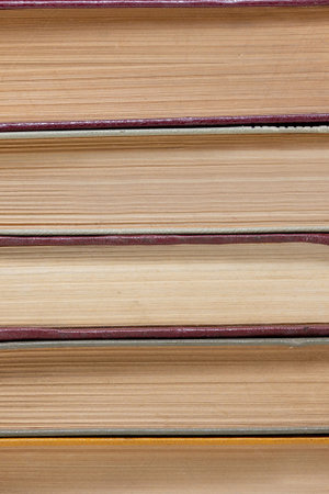 chaotic stack of old books background, selective focus.
