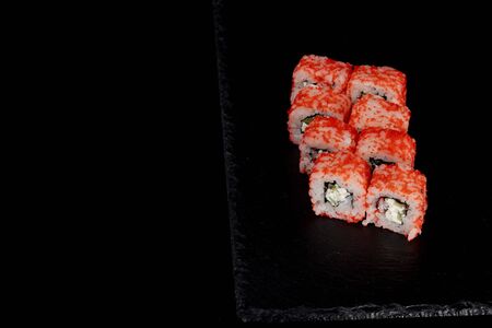 Philadelphia roll with salmon, cheese and cucumber on a black background. Sushi Philadelphia.の写真素材