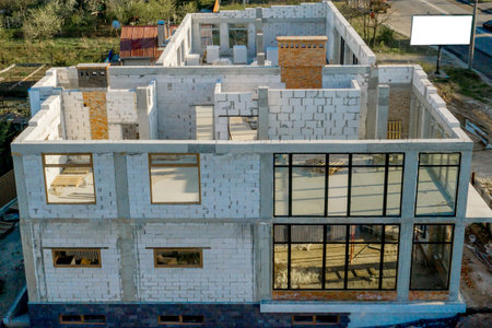 Building site of a house under construction made from white foam concrete blocks. Building new frame...
