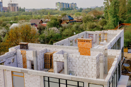 Building site of a house under construction made from white foam concrete blocks. Building new frame...