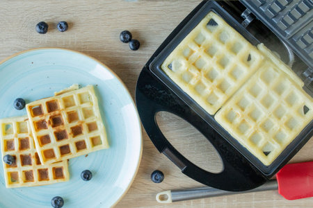 Waffles Being Baked in the Waffle Maker. Savory waffles. Breakfast concept.