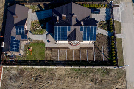 Kyiv- Dec 11 ,2019: Aerial top view of a private house with paved yard with green grass lawn with concrete foundation floor.のeditorial素材
