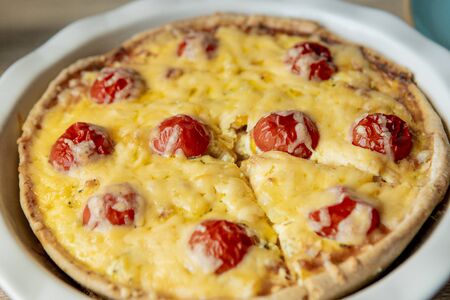 Homemade quiche lorraine with chicken, tomatoes and cheese. French cuisine. Selective focus. Top view. Copy space.の写真素材