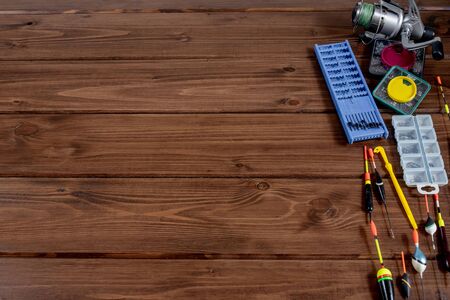 fishing tackle - fishing rod fishing float and accessories on wooden background, copy spaceの写真素材