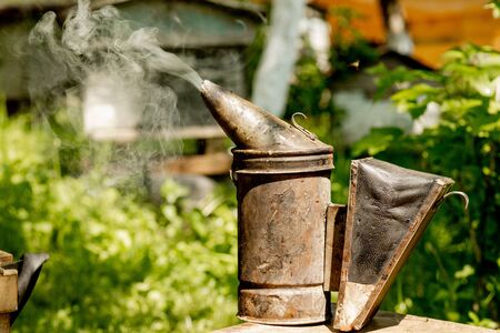 Chimney for flashing bees. Chimney stands near beehives.The beekeeper.の写真素材