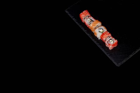 Philadelphia roll with salmon, cheese and cucumber on a black background. Sushi Philadelphia.の写真素材