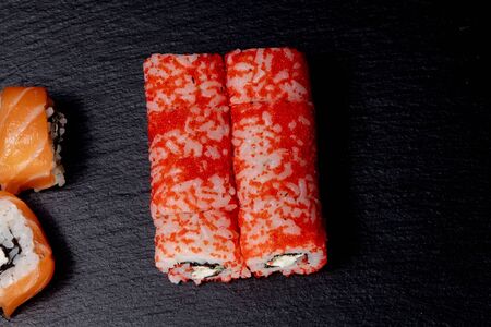 Philadelphia roll with salmon, cheese and cucumber on a black background. Sushi Philadelphia.の写真素材