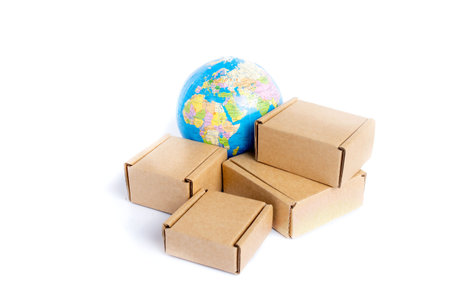 Earth globe is surrounded by boxes isolated on white background. Global business and international...