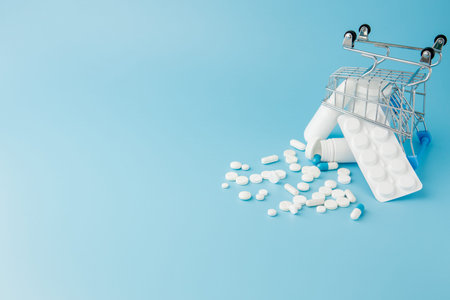 scattered variety pills, drugs, spay, bottles, thermometer, syringe and empty shopping trolley cart...