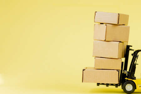 Mini forklift truck load cardboard boxes. Logistics and transportation management ideas and Industry business commercial conceptの写真素材
