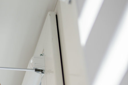 Man installing cassette roller blinds on windows.