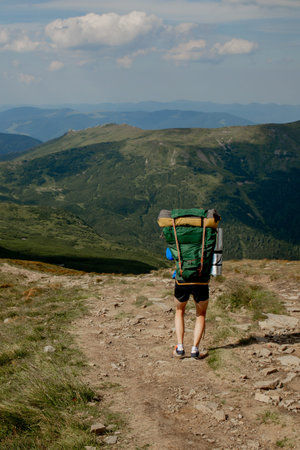 Hiker on the top in Carpathians mountains. Travel sport lifestyle concept.
