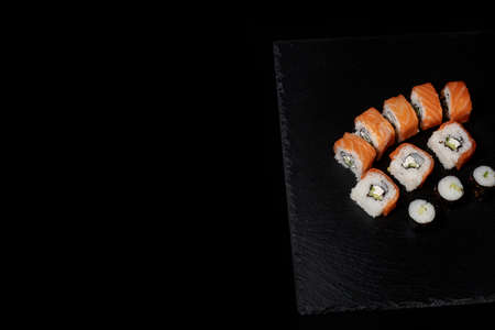 Philadelphia roll with salmon, cheese and cucumber on a black background. Sushi Philadelphia.の写真素材