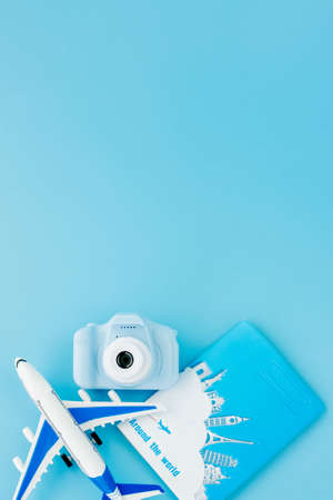 Camera, passport and airplane on light blue background.Summer or vacation concept. Copy spaceの写真素材