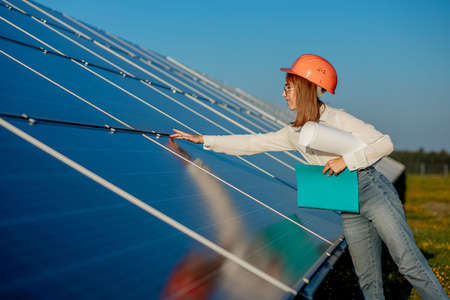 Businesswomen working on checking equipment at solar power plant with tablet checklist, woman working on outdoor at solar power plant.の写真素材